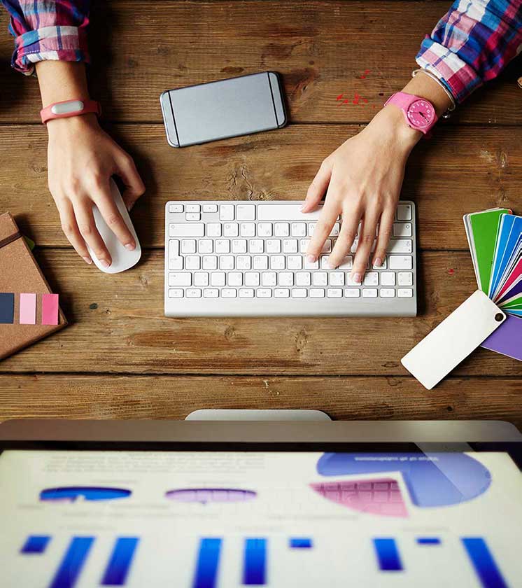 Woman typing on keyboard using SEO graphs.